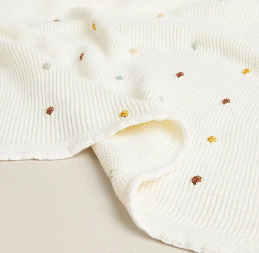 Nordic Pompom Baby Blanket: Cozy and Adorable -